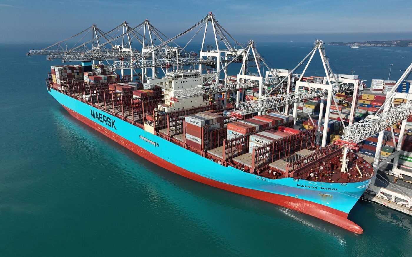 A container ship loaded with stacked shipping containers at port